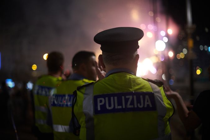 Back of Maltese policemen walking at night