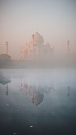 Taj mahal, India in fog with reflection on water