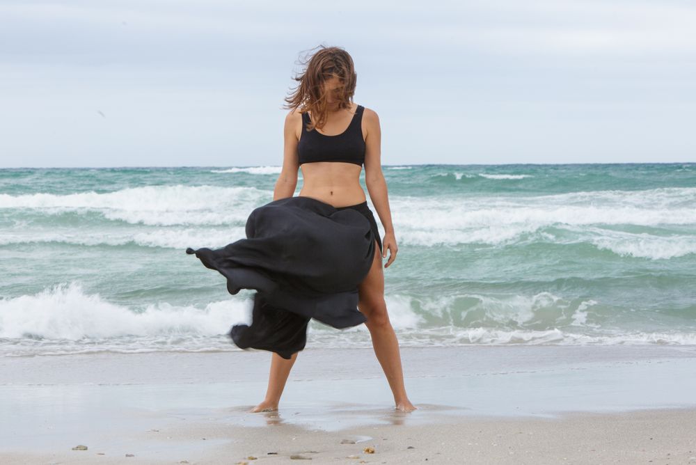 woman dancing near sea