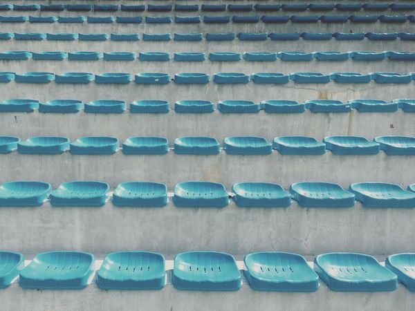 Blue plastic seats on large concrete stairs