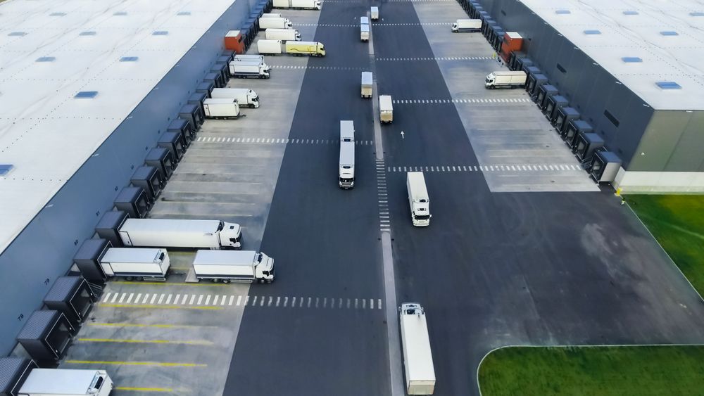 Aerial Shot of Loading Area where Many Trucks Are Loading