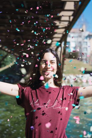 Woman throwing confetti in the air.