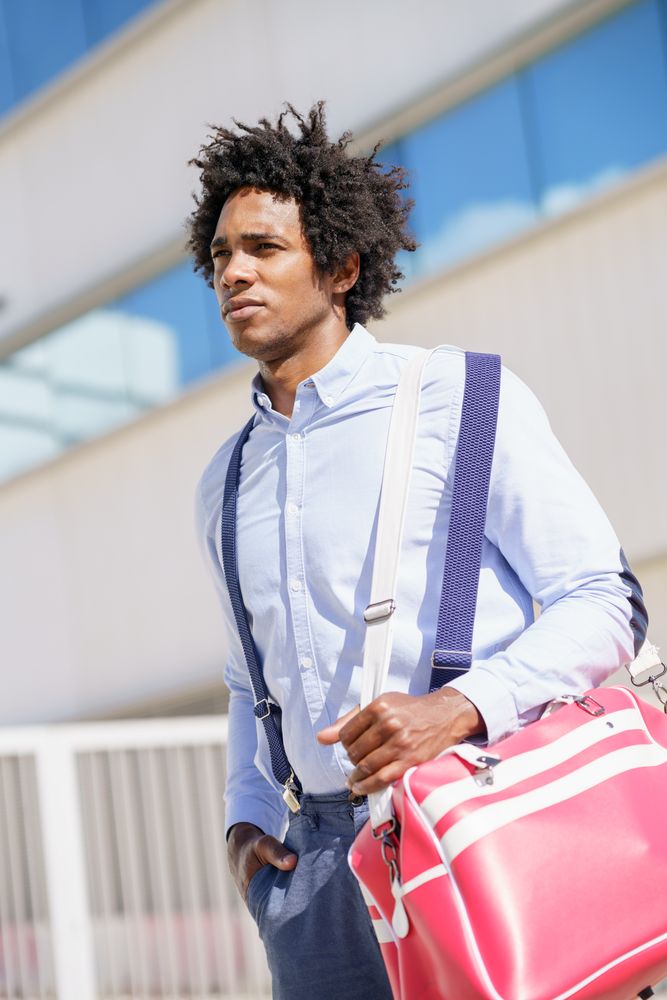 Black male in smart casual leaving work with sports bag