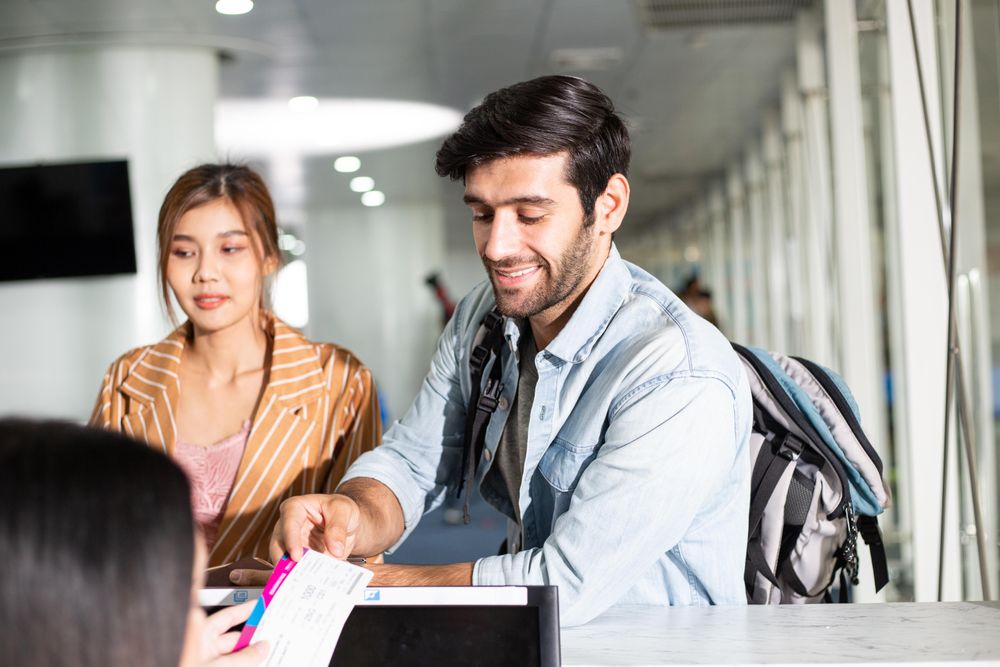 Man and woman checking in for flight at airport