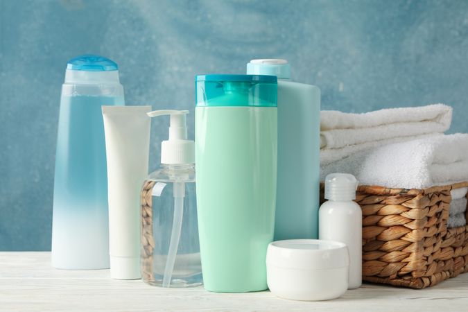 Body care products on blue background. Personal hygiene