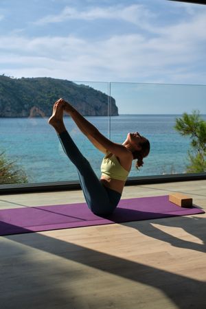Slim woman practicing yoga in Boat pose