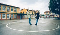 Couple standing together holding hands in circle in sports court