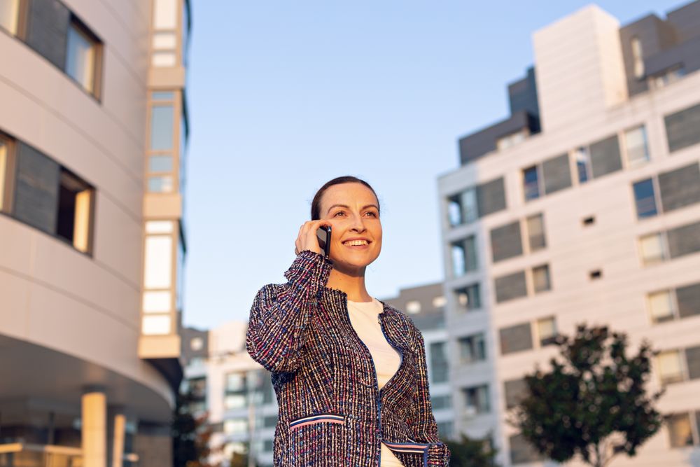 Smiling businesswoman answering phone call