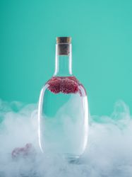 Bottle with drink between fog