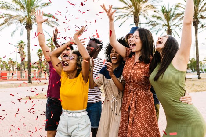 People having fun with confetti at summer party