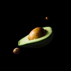 Space scene with fruits as stars and planets on dark background