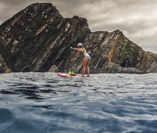 Woman on paddleboard floating in sea