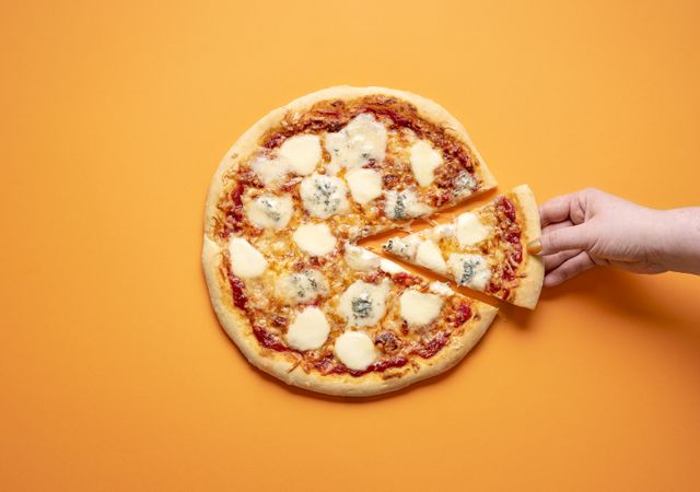Grabbing cheese pizza slice from whole pizza