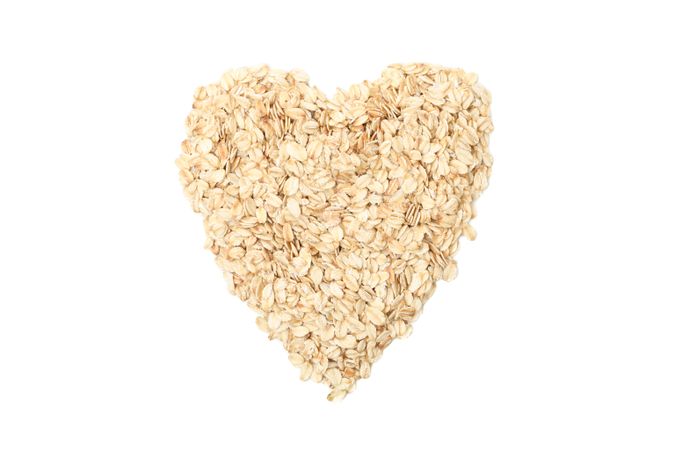 Heart made of oatmeal flakes isolated on blank background