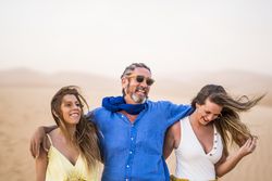 Happy friends walking in desert