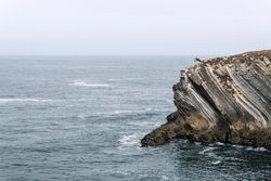 Rocky formations in the island of Baleal on the Atlantic coast in a foggy day. Peniche, Portugal