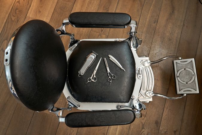 Hairdressing tools on leather chair in barbershop