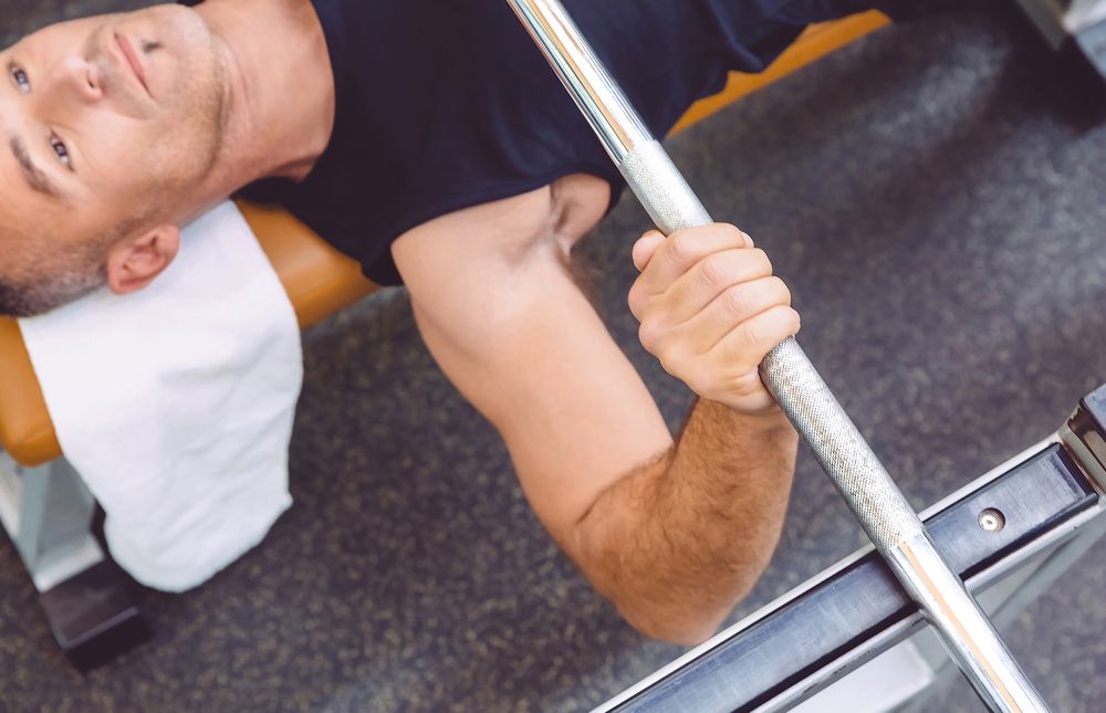 Close up of male bench pressing