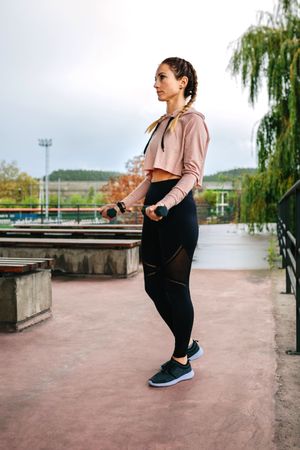 Young woman training with dumbbells