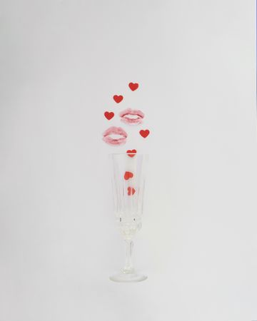 Champagne flute with lipstick mark and hearts