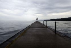 Shot of Two Harbors Light House with forest and clouds in the background