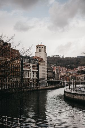 Cloudy sky over buildings and channel