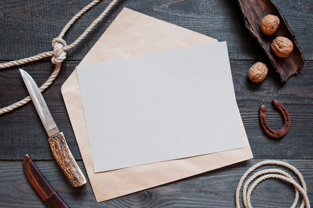 Top view of envelope, paper note and envelope opener