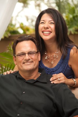 Portrait of Laughing In Front Of Fern With Woman Holding Man