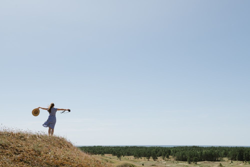 Young female photographer on forest