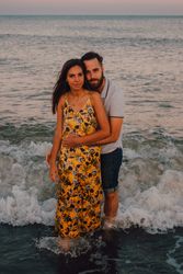 Loving couple embracing happily on sandy beach