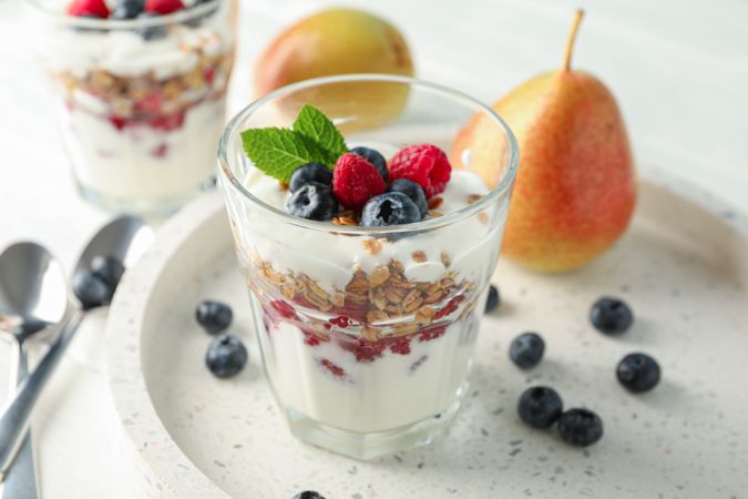 Parfaits and pears on wooden table, space for text