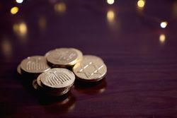 Pile of golden gelt for Hanukkah with copy space