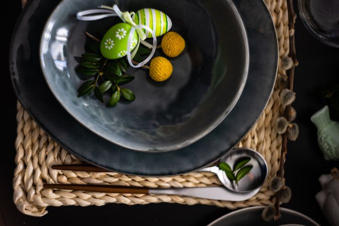 Top view of dark plate with decorative Easter eggs
