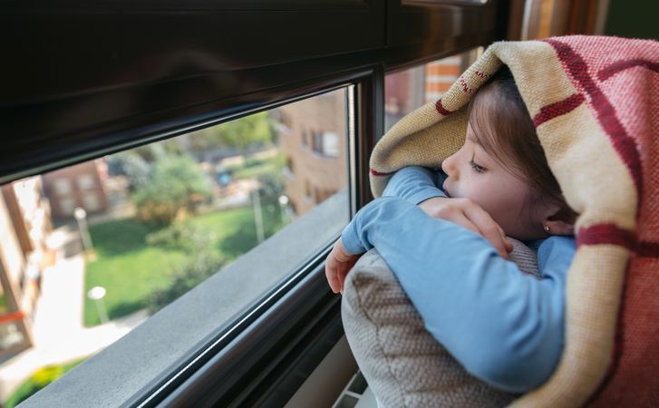 Sad girl looking out the window