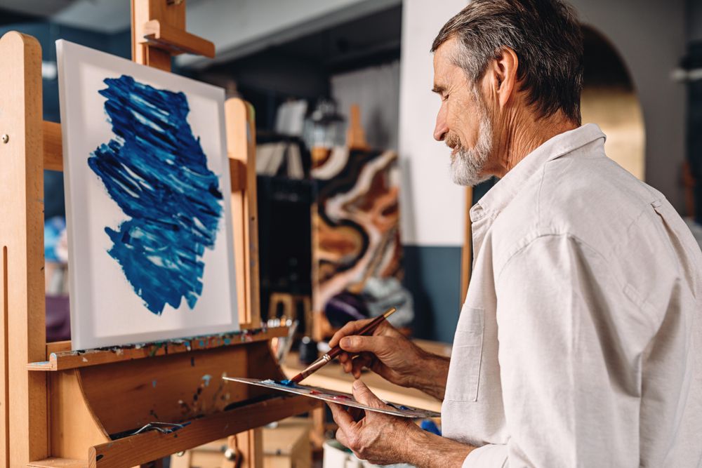 Mature man artist working in art studio