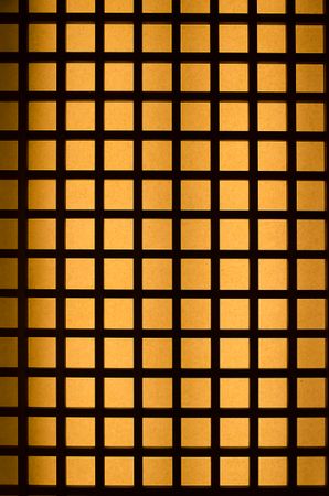 Orange light through wood square pattern
