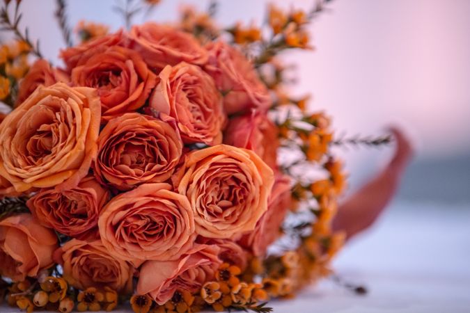 Pink roses in brown wicker basket