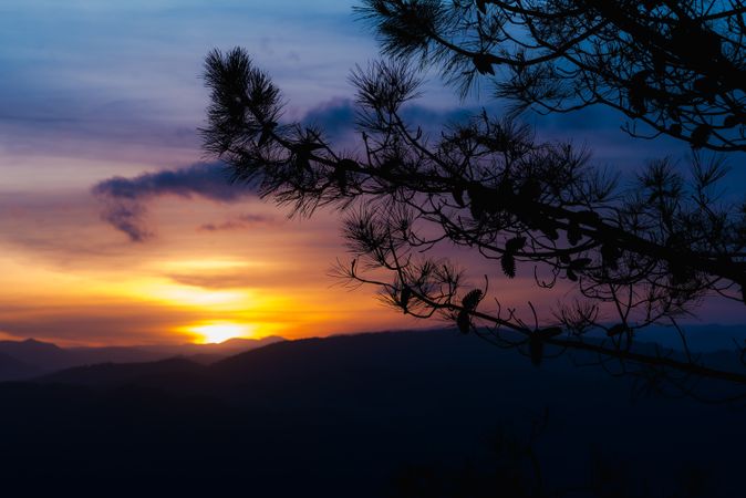 Cloudy sunset sky over hills