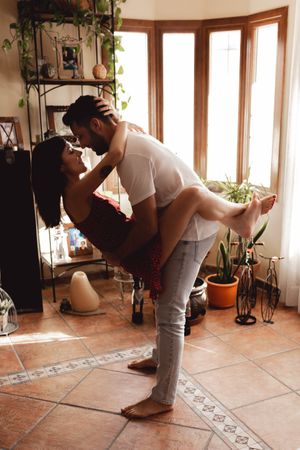 Passionate couple hugging in stylish room