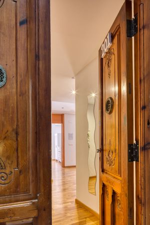 Interior of flat through open wooden doors