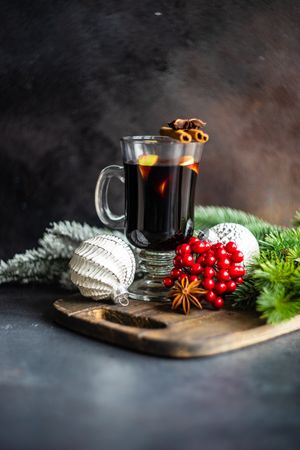 Mulled wine on bread board with Christmas decorations