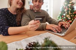 Couple shopping online for christmas with credit card and laptop 5aXjxv