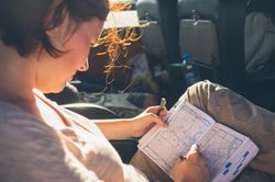 Traveler making notes on map