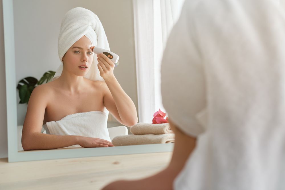 Woman cleaning pores with modern blackhead remover