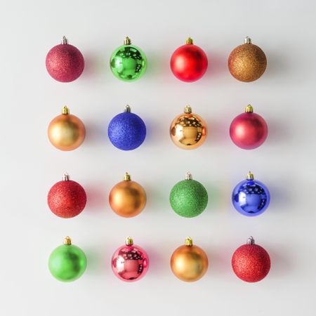 Multi-colored Christmas baubles decoration on light background