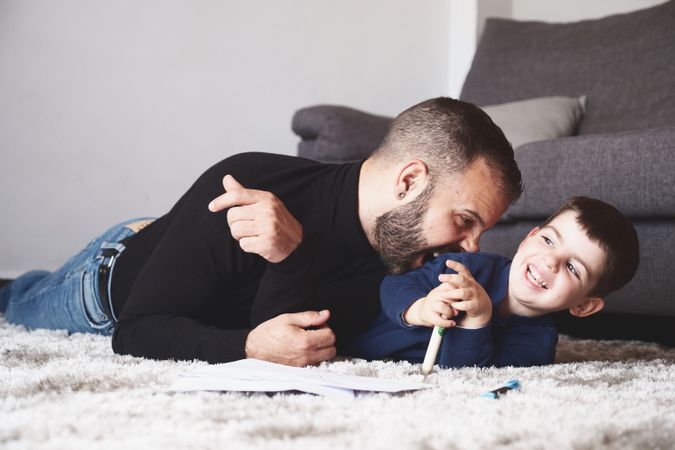 Father and son drawing on floor