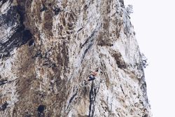 Anonymous man climbing rock