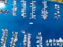 Top down travel photo of a vessel navigating into a port.