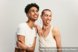 Male couple smiling on light background. 0VNqD0