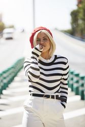 female in red beret outdoors
